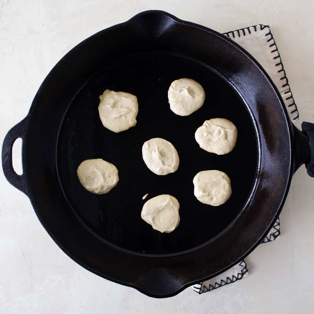 3 ingredient pancake batter in a cast iron pan.