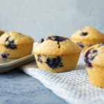 Blueberry muffins sitting around on the cupboard.