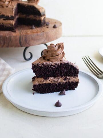 A two layer slice of chocolate cake with chocolate frosting.