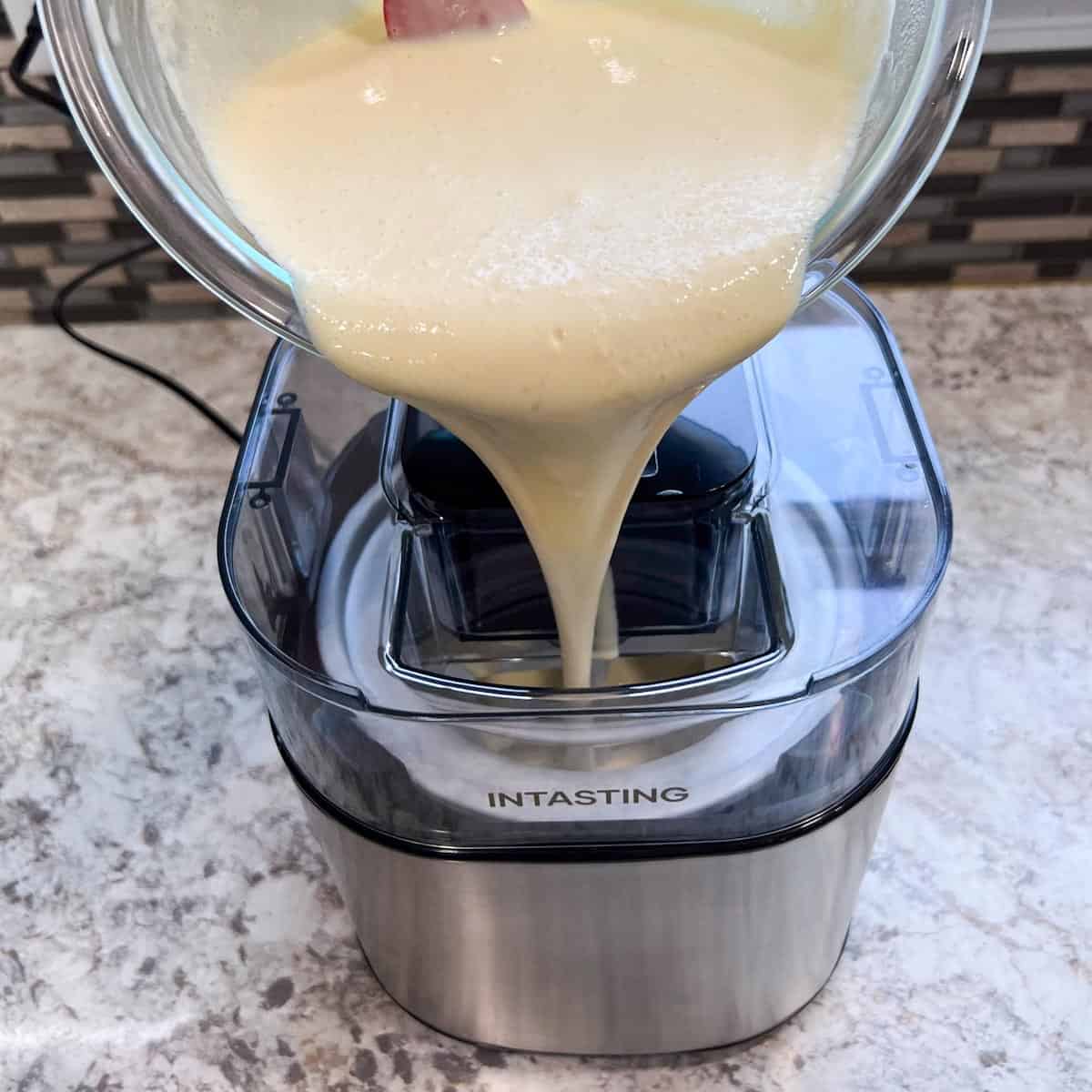 Dumping ice cream mix into an ice cream maker.