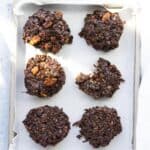 6 no bake cookies on a parchment lined tray.