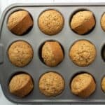 A muffin tin full of zucchini muffins.