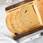 Slices sliced off the end of a loaf of whole wheat bread.