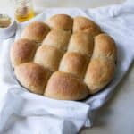 Whole wheat rolls on a plate.