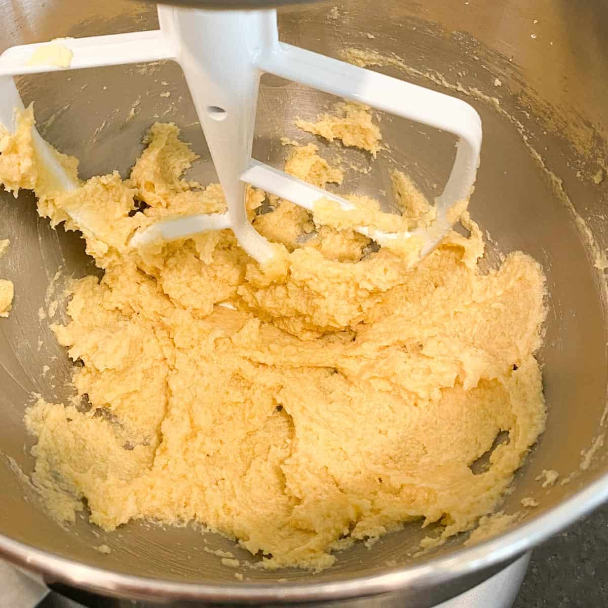 Butter, sugar and egg creamed together in a bowl.