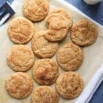 Whole wheat snicker doodle cookies arranged on a piece of parchment paper.
