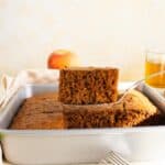 Lifting a slice of apple cake out of the pan.