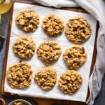 Oatmeal raisin cookies on a board.