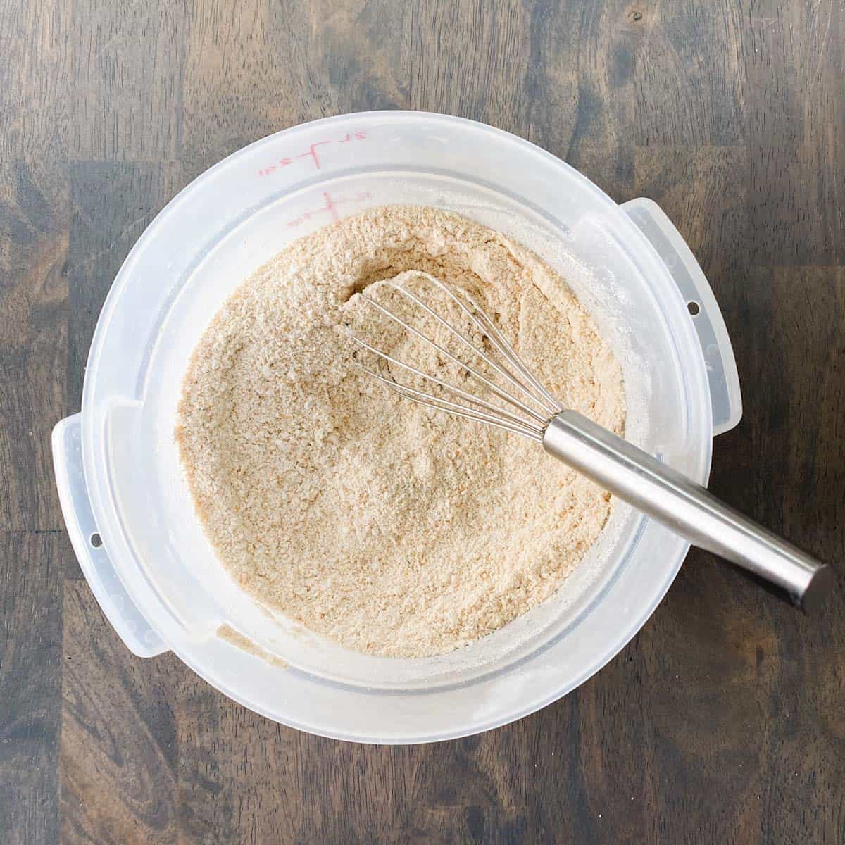 Flour and other dry ingredients mixed together in a container.