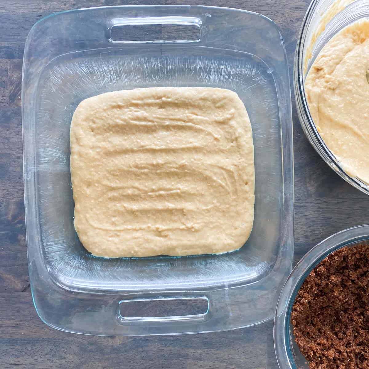 Coffee cake batter in a glass baking dish.