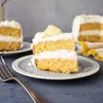 2 layer lemon cake slice on a plate.
