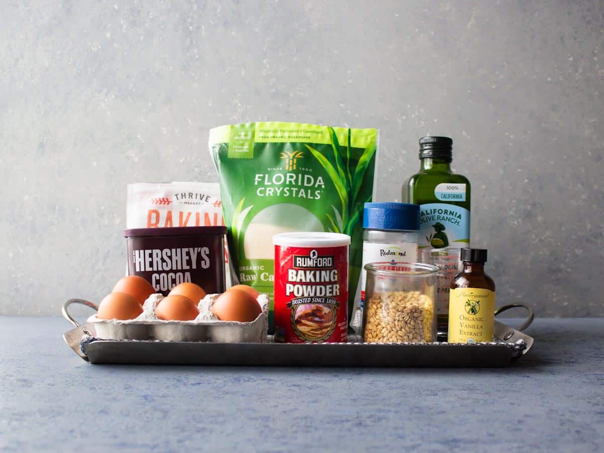 Ingredients for for whole wheat chocolate cupcakes in original containers on a tray. 