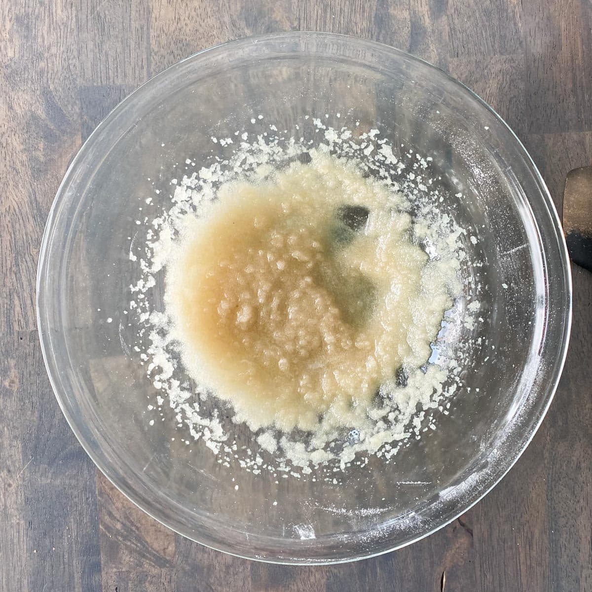 Oil and sugar mixed together in a bowl.
