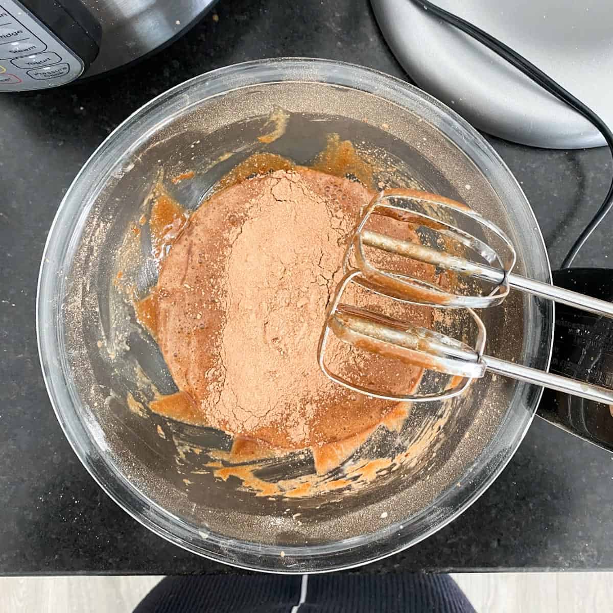 Adding dry ingredients to chocolate cupcake batter.