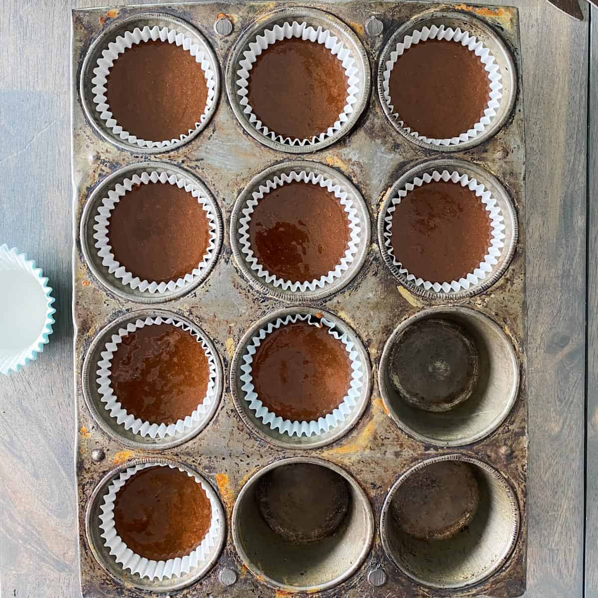 Whole wheat chocolate cupcake batter in a cupcake pan.
