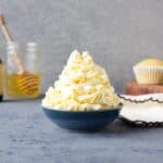 Frosting piped into a blue bowl.
