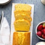 A loaf of whole wheat pound cake with a few slices cut off the end and laid out.