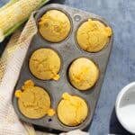 Cheddar and green chili corn muffins just after baking in a muffin tin.